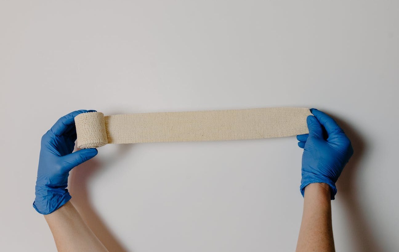 a person holding a gauze tape
